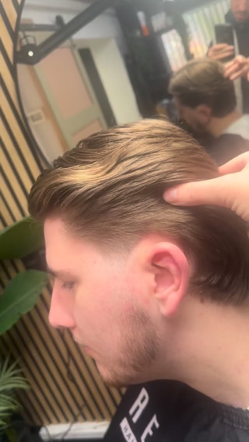 A blonde side sweep over a short back.