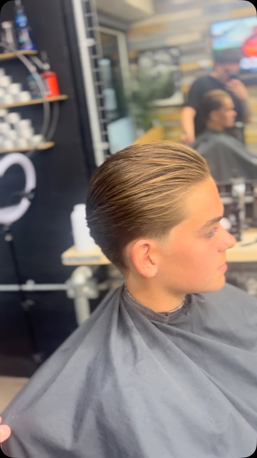 Long hair slicked back and finished.