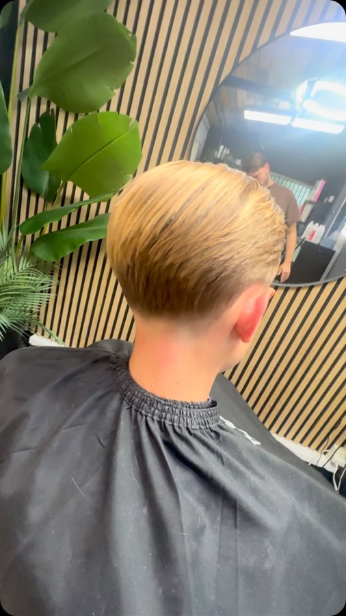 A blunt fringe over a tapered back and sides.