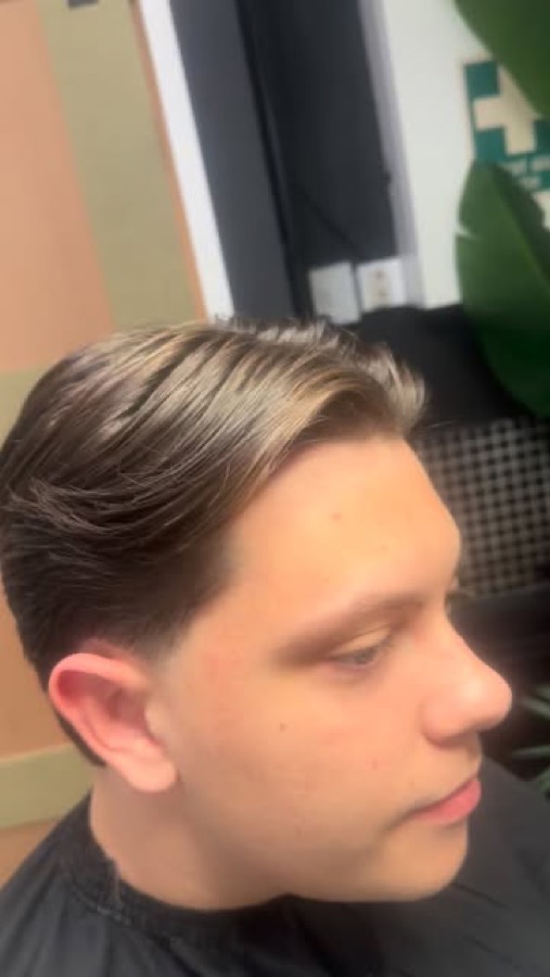 Blonde hair slicked back off the face.
