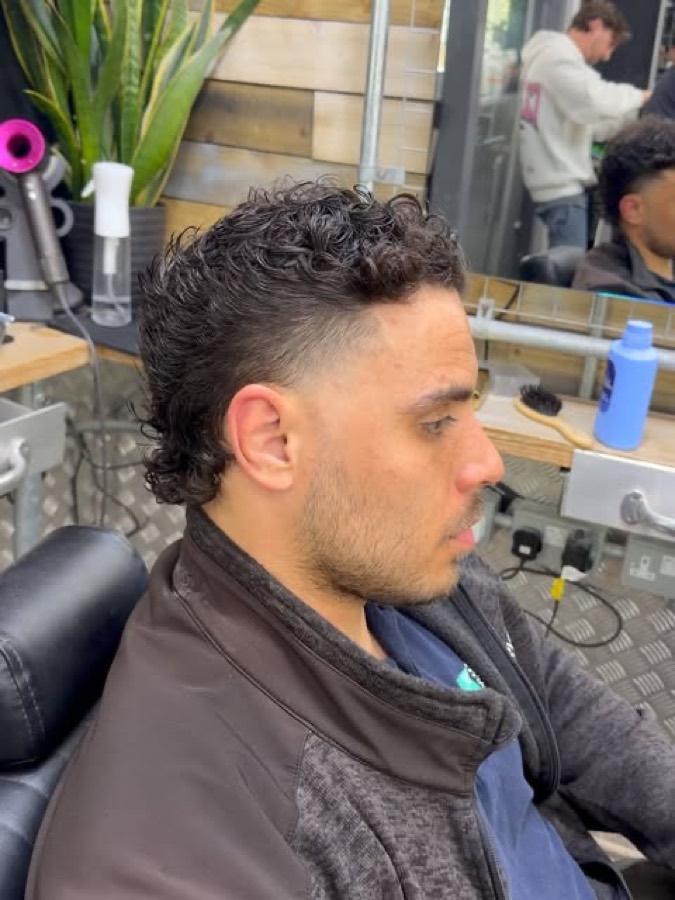 Curls kept full over a tight fade.