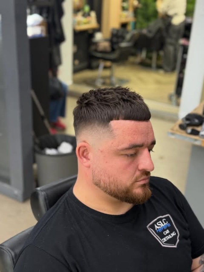 A skin fade with a lined beard.