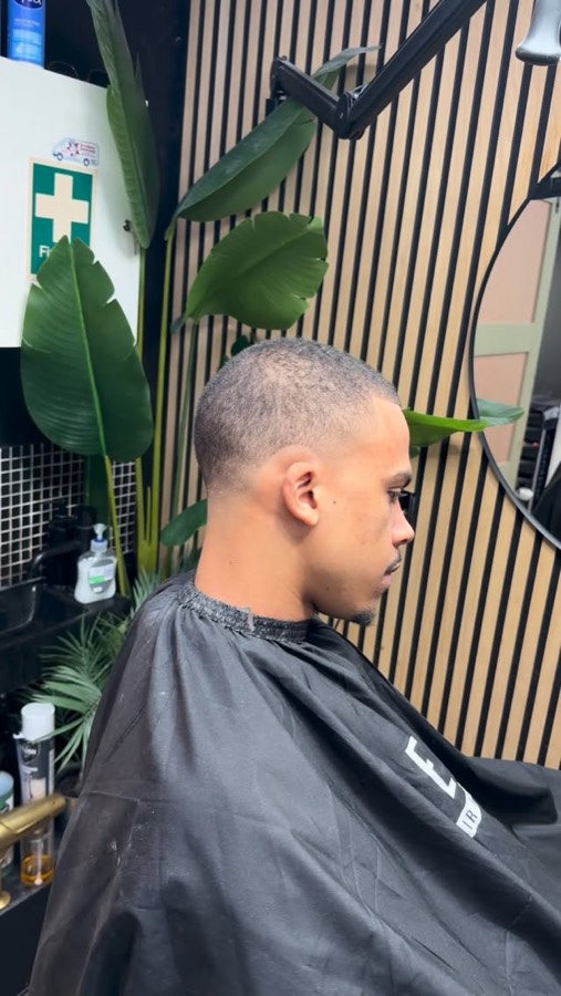 A short skin fade, side profile.